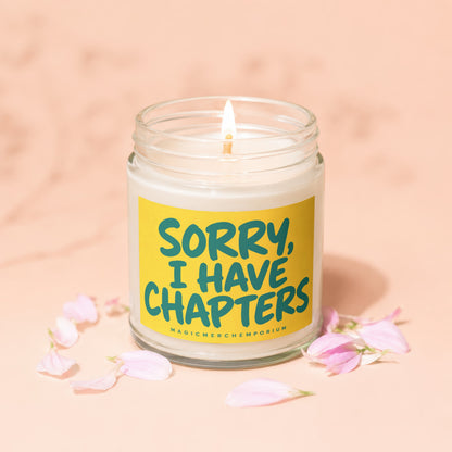 Candle with yellow label reading "SORRY, I HAVE CHAPTERS" surrounded by pink petals.