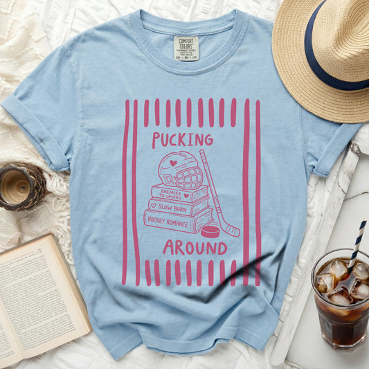 Light blue t-shirt with "Pucking Around" hockey romance design.