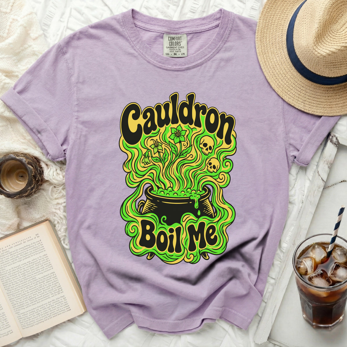 Purple t-shirt with "Cauldron Boil Me" graphic and skulls.
