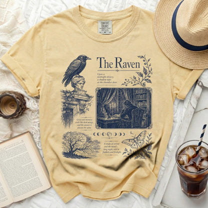 Yellow t-shirt with "The Raven" literary print featuring a raven, library scene, and moon phases.