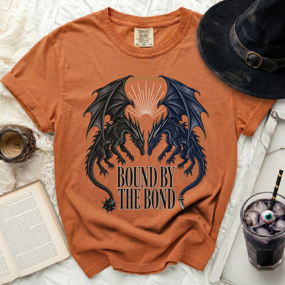 Orange Comfort Colors t-shirt with black and blue dragons and text "BOUND BY THE BOND".