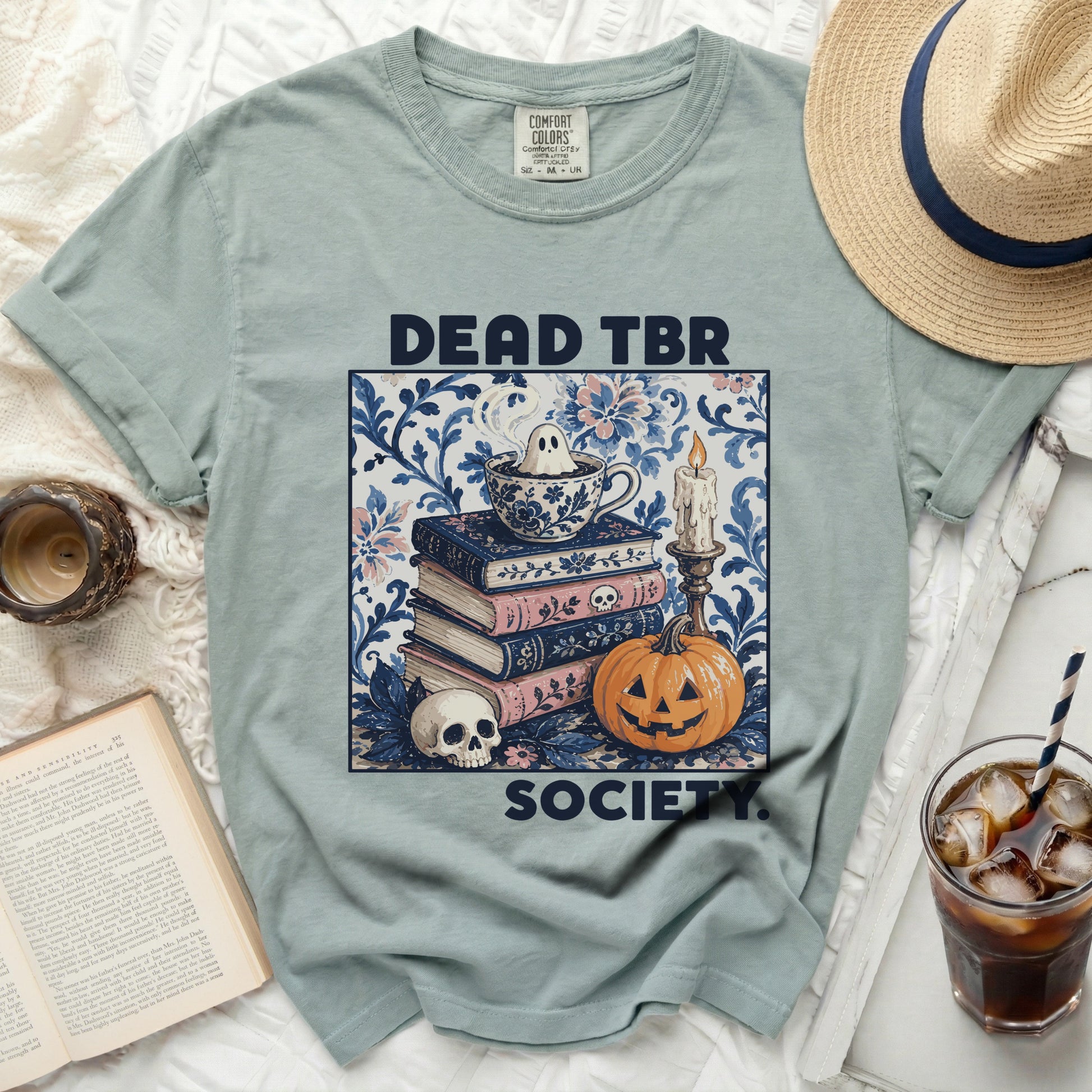 Green t-shirt with "DEAD TBR SOCIETY" text and Halloween book illustration.