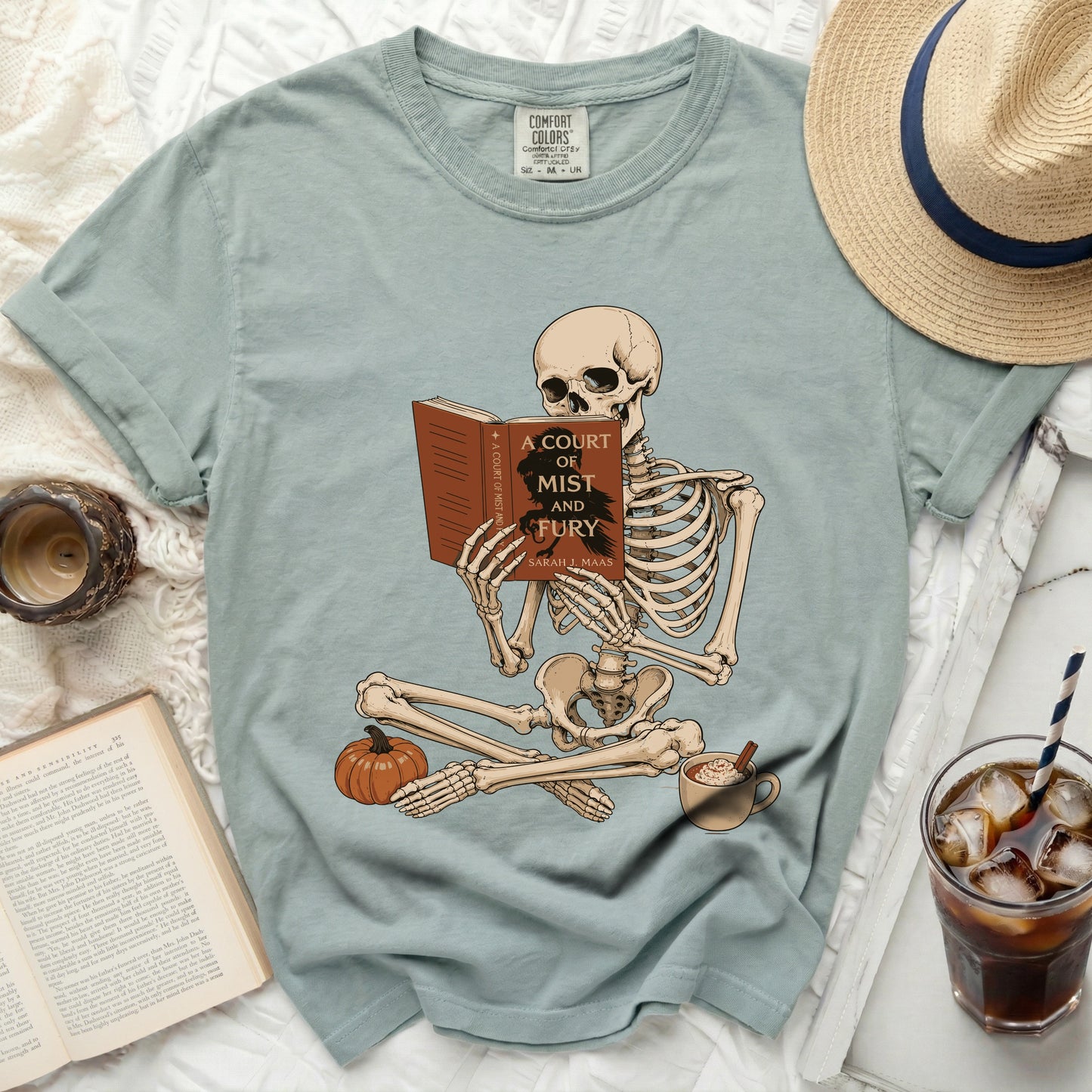 Skeleton reading "A Court of Mist and Fury" book by Sarah J. Maas.