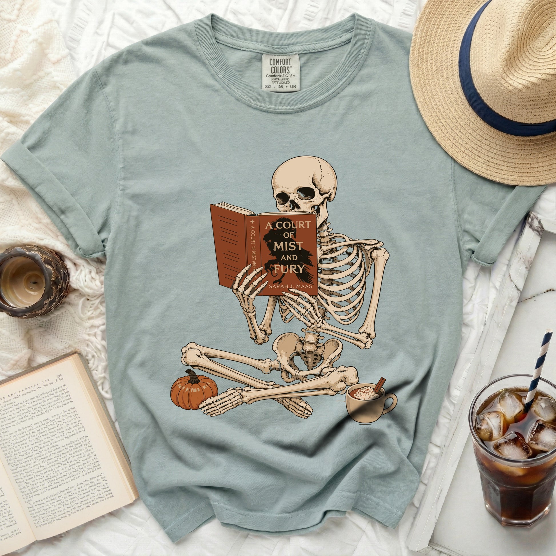 Skeleton reading "A Court of Mist and Fury" book by Sarah J. Maas.