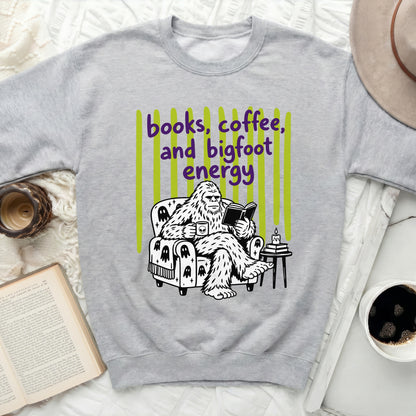 Bigfoot reading a book, holding coffee on a chair with ghost patterns.