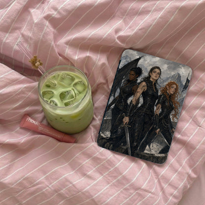 Phone case with three fantasy women in armor, beside green drink and lip balm.