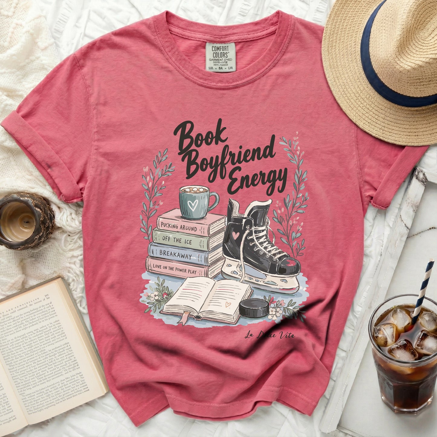 Pink t-shirt with "Book Boyfriend Energy" text and ice skate illustration.