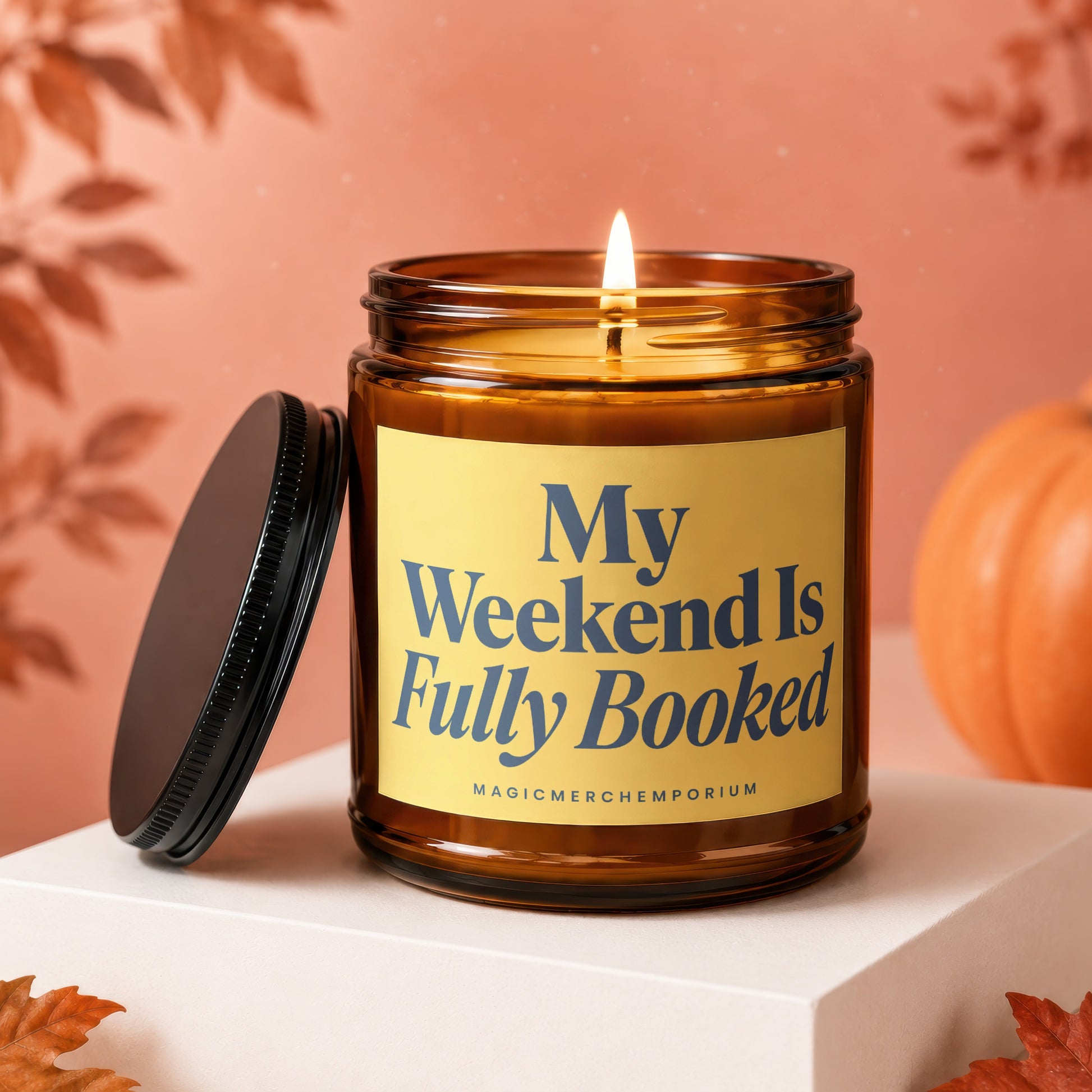 Amber candle burning on white pedestal with text "My Weekend Is Fully Booked."