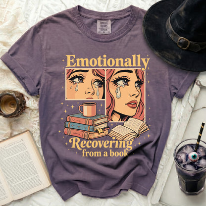 Purple t-shirt with "Emotionally Recovering from a book" graphic.