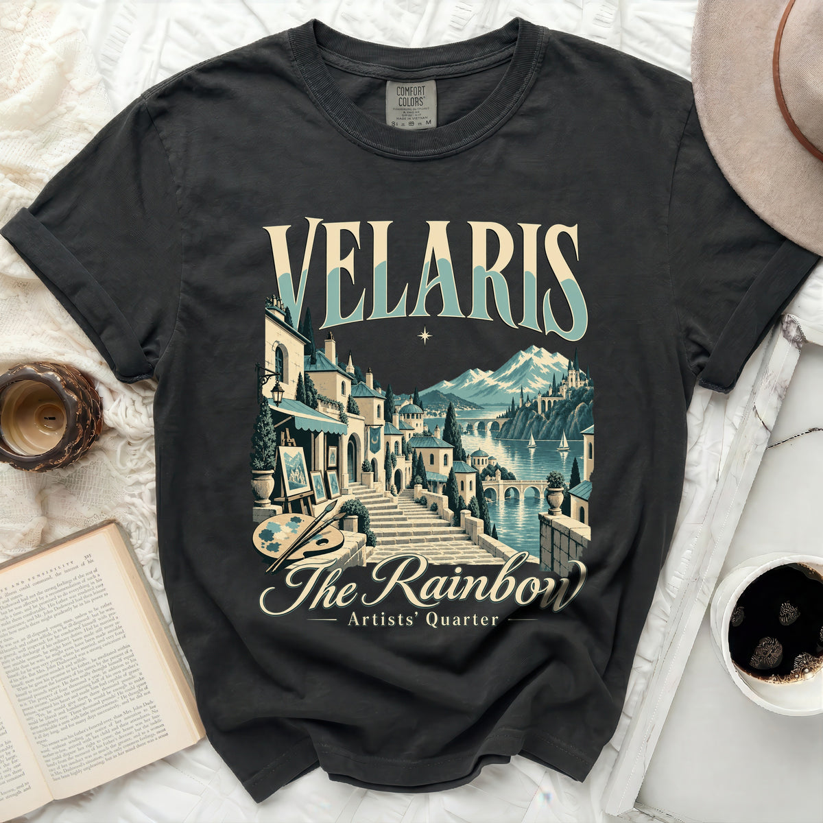 Dark grey t-shirt with "Velaris The Rainbow Artists' Quarter" graphic.