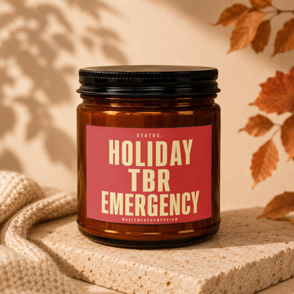 Amber candle with red label reading "Status: Holiday TBR Emergency"