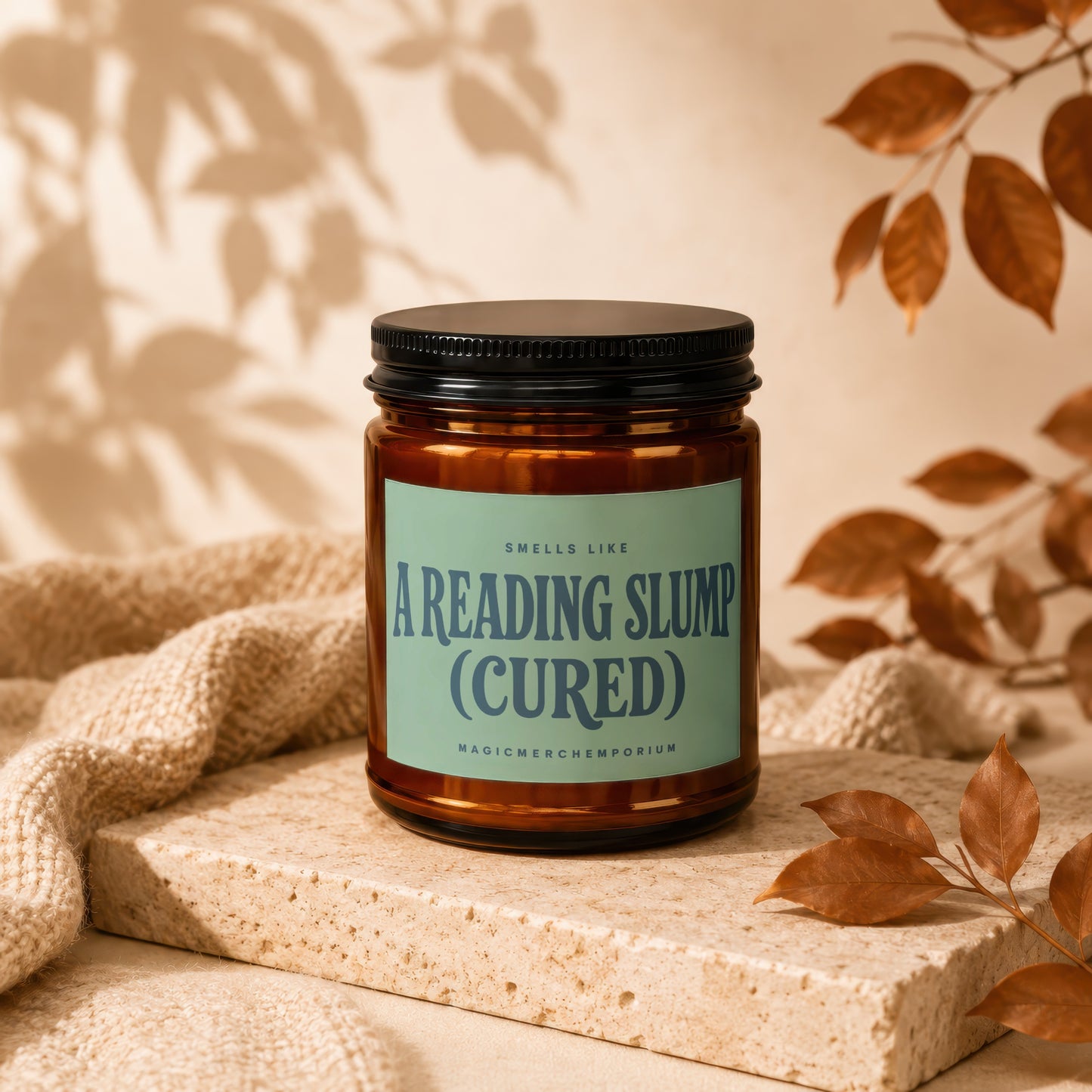 Amber candle with a light green label reading "Smells Like A Reading Slump (Cured)".