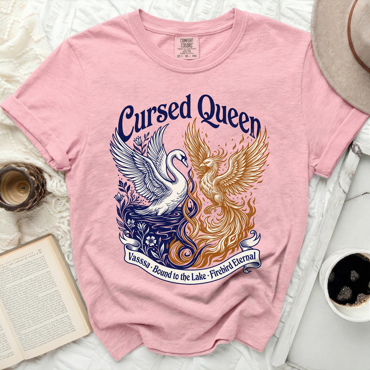 Pink t-shirt with "Cursed Queen" graphic of a swan and phoenix.