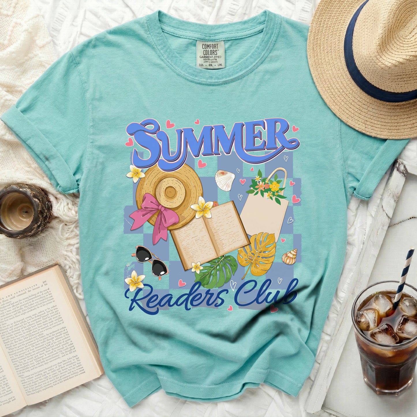 Aqua t-shirt with "Summer Readers Club" graphic, straw hat, book, and iced drink.