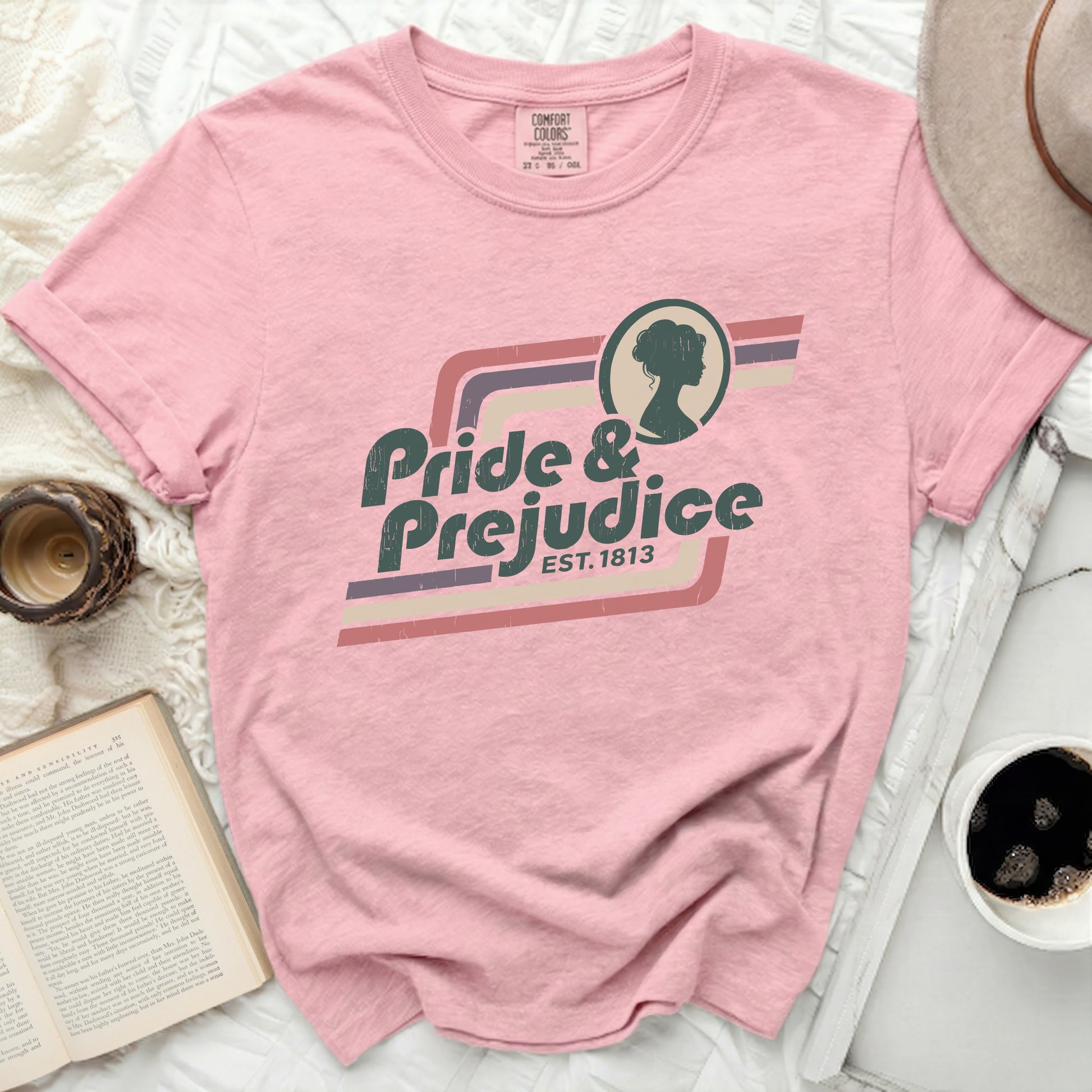 Pink t-shirt with "Pride & Prejudice Est. 1813" graphic and silhouette.