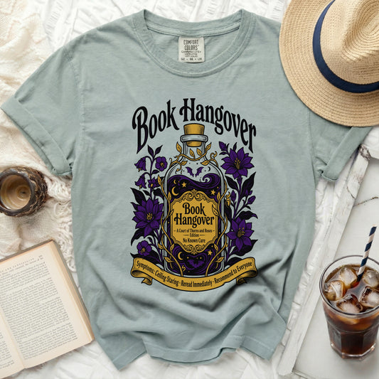 T-shirt with "Book Hangover" design featuring a potion bottle and flowers.