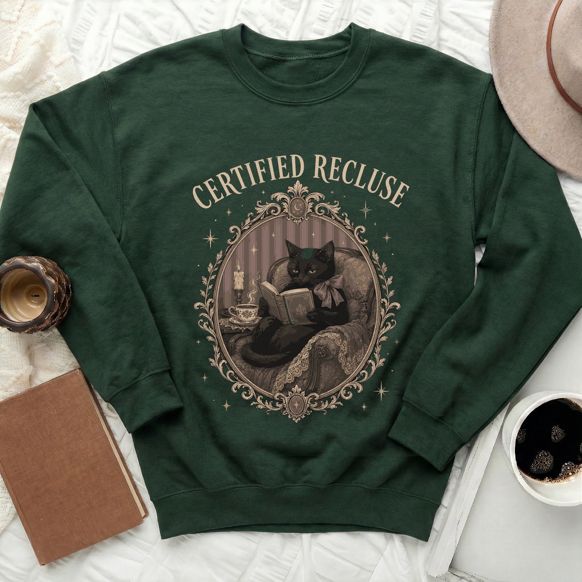 Green sweatshirt with "Certified Recluse" text and illustration of a black cat reading.