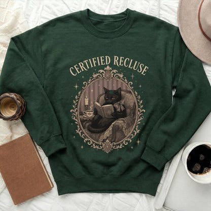 Green sweatshirt with "Certified Recluse" text and illustration of a black cat reading.