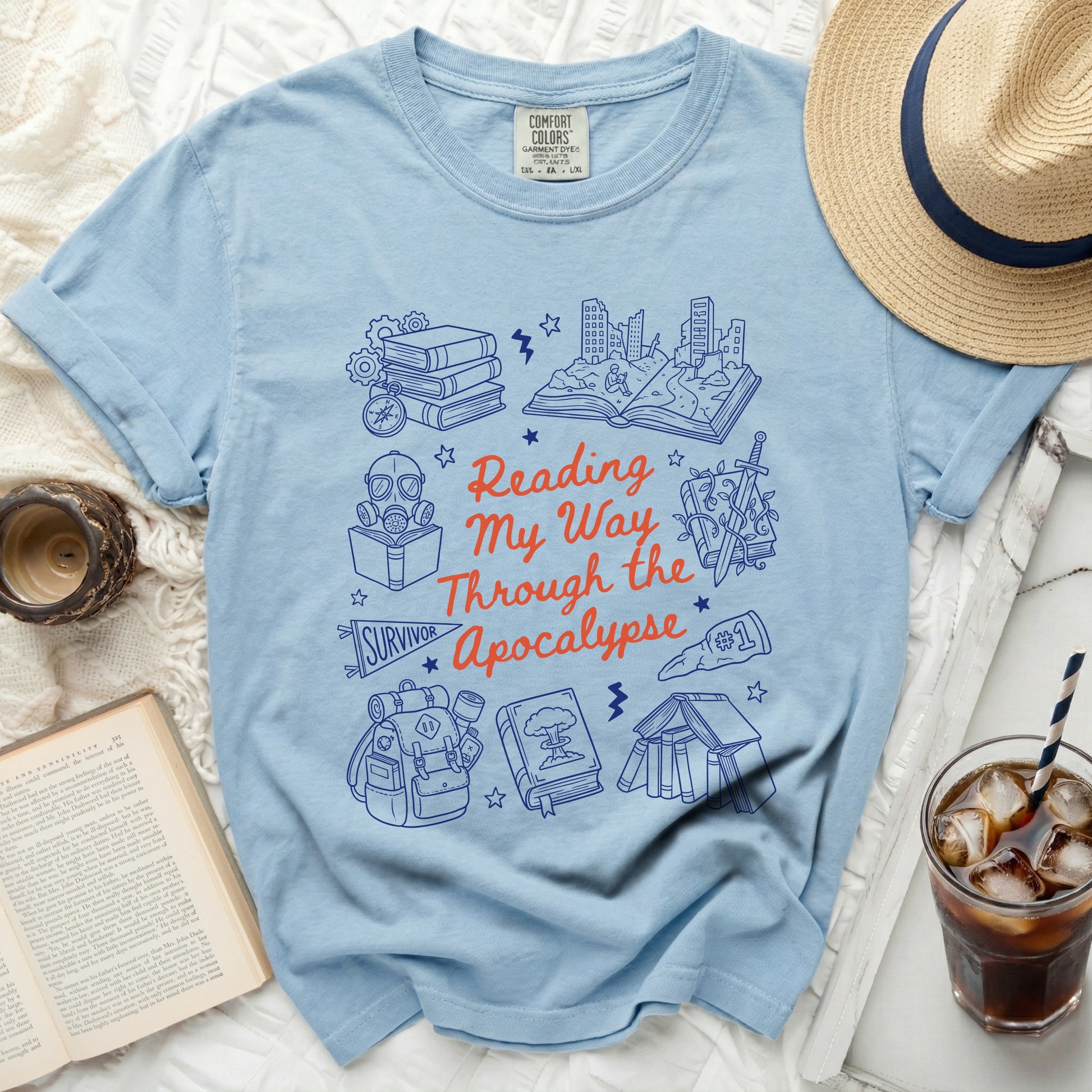 Blue t-shirt with "Reading My Way Through the Apocalypse" graphic and survival icons.