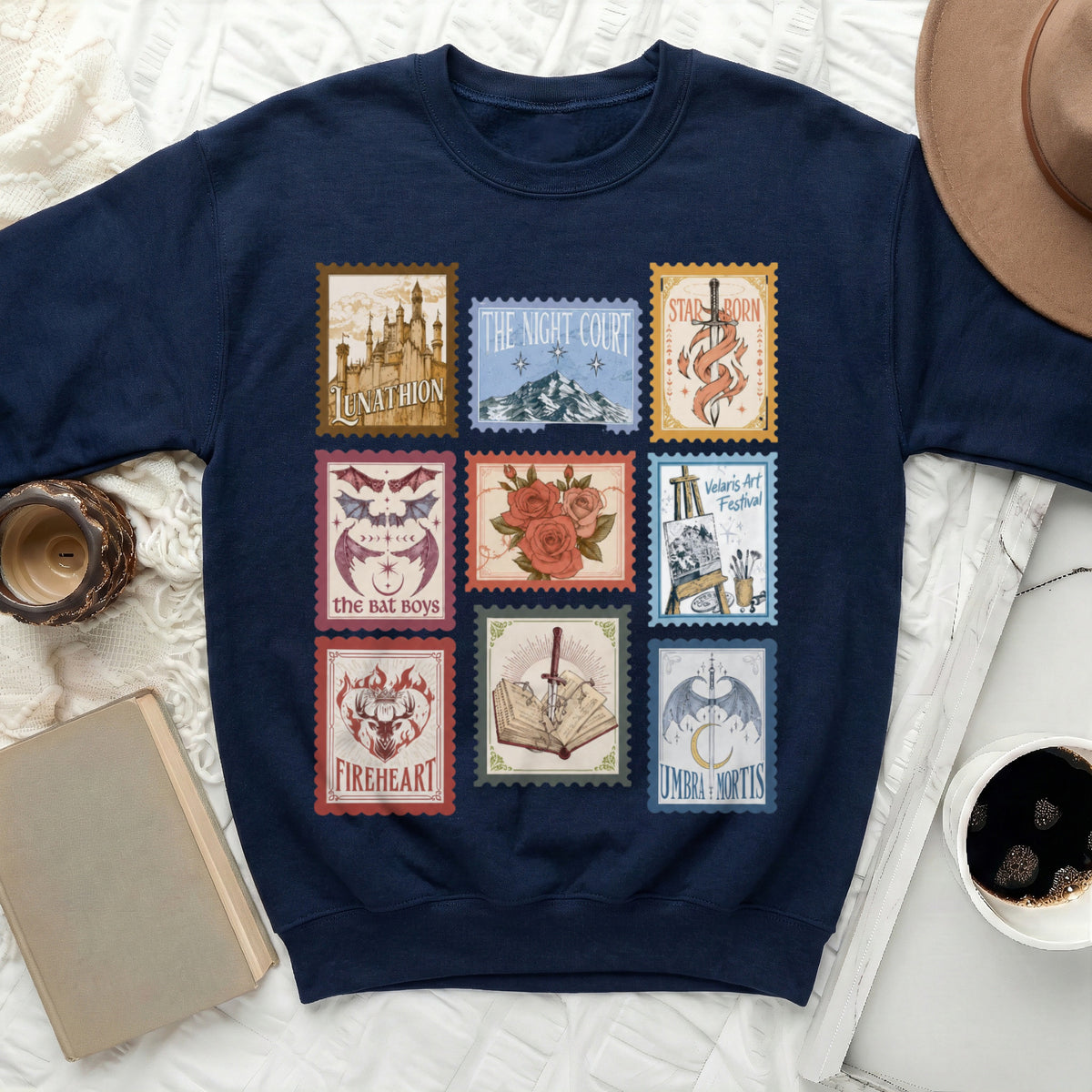 Navy sweatshirt with a print of nine fantasy-themed postage stamps.