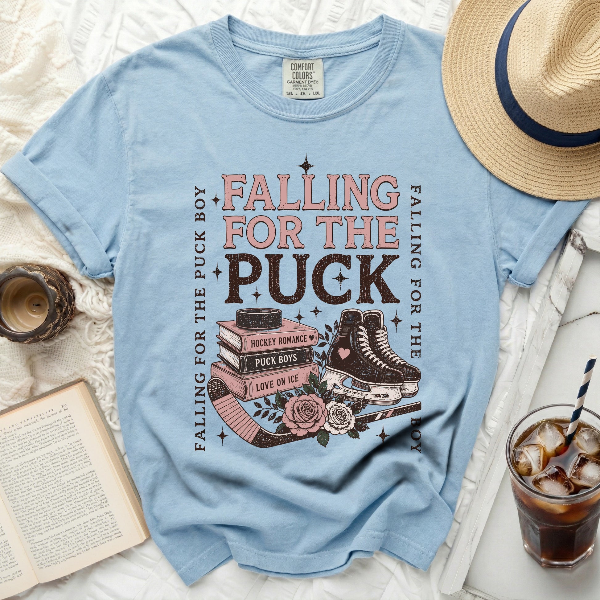 Light blue t-shirt with "Falling for the Puck" text, hockey skates, and roses.