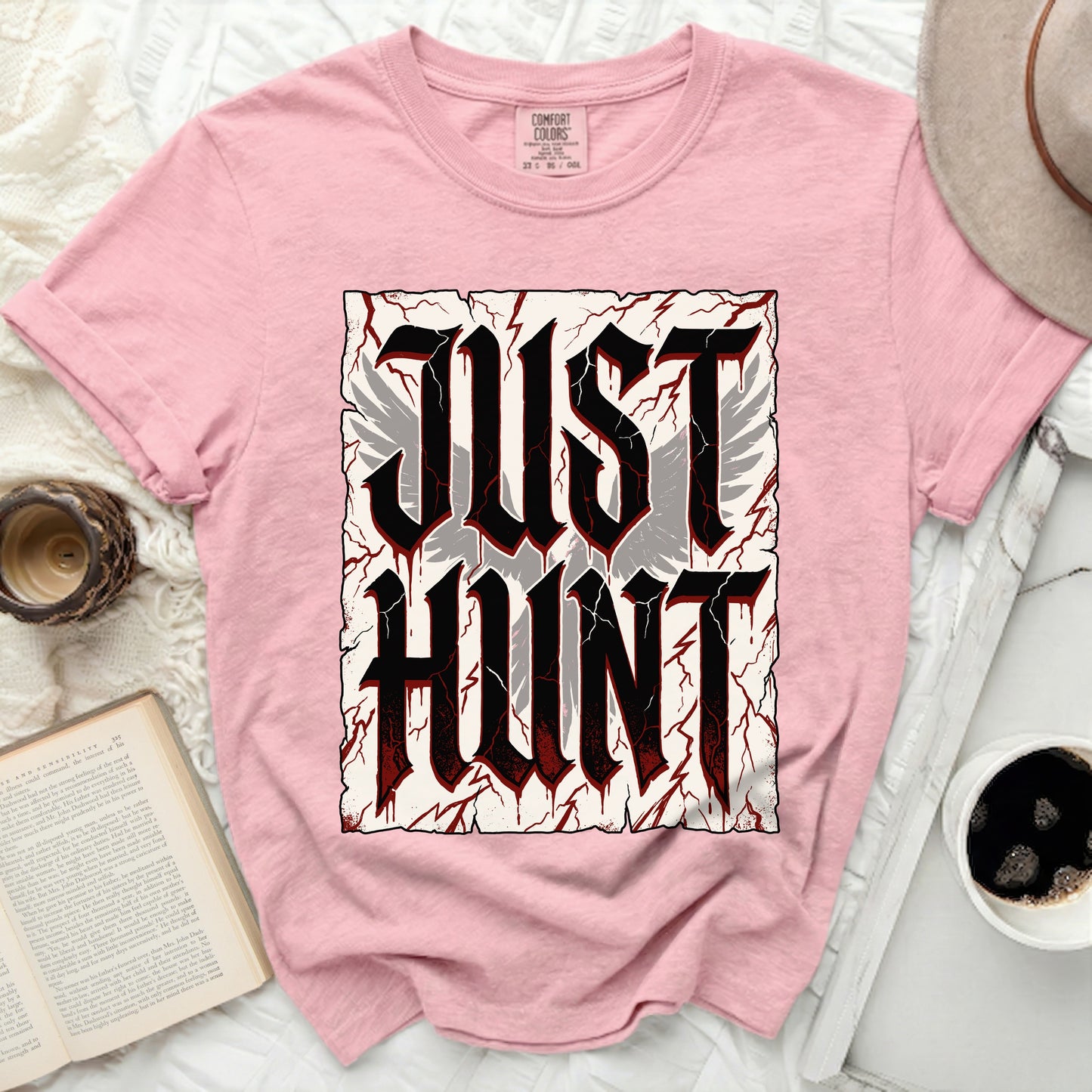 Pink t-shirt with "JUST HUNT" in gothic font and feathered wings.