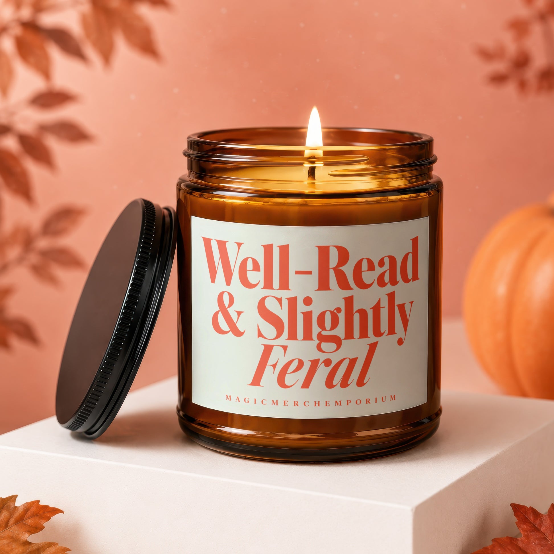 Amber jar candle with lit wick, lid beside, text "Well-Read & Slightly Feral".