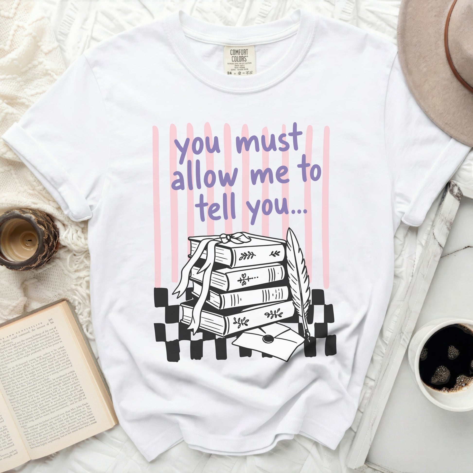 White t-shirt with text "you must allow me to tell you..." and book illustration.