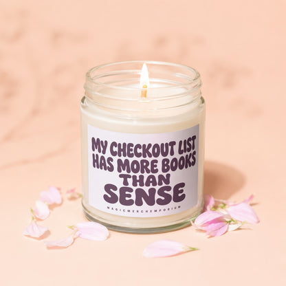 Candle with text "My checkout list has more books than sense".