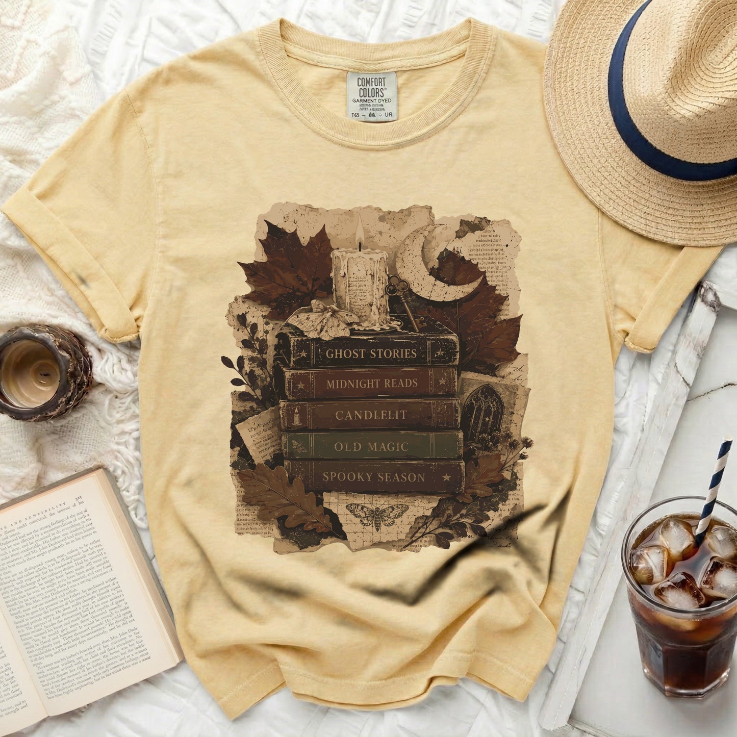 Yellow t-shirt with "Ghost Stories", "Midnight Reads", "Candlelit", "Old Magic", "Spooky Season" book graphic.