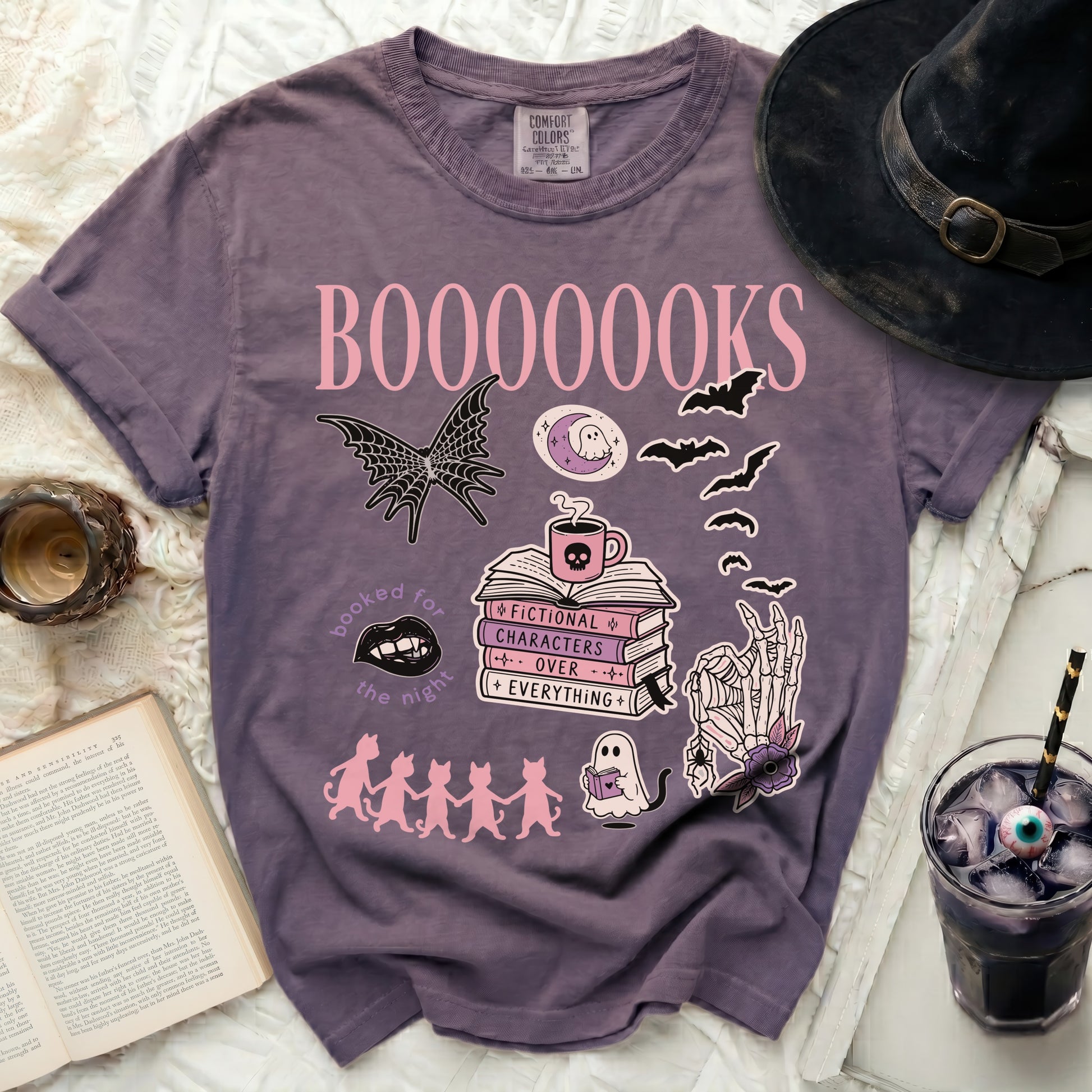 Purple t-shirt with "BOOOOOOKS" and Halloween-themed book graphics.