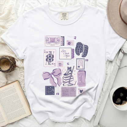White t-shirt with "Love, Check Mate" text and ice skating and book-themed graphics.