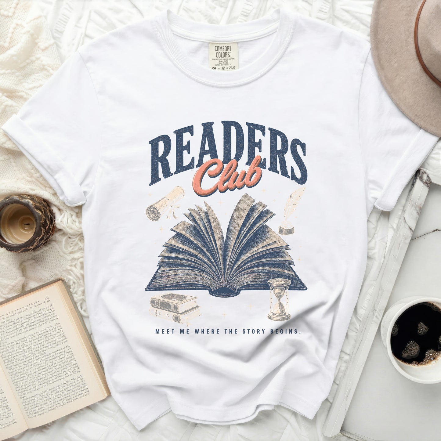 White t-shirt with an open book, quill, and hourglass design.