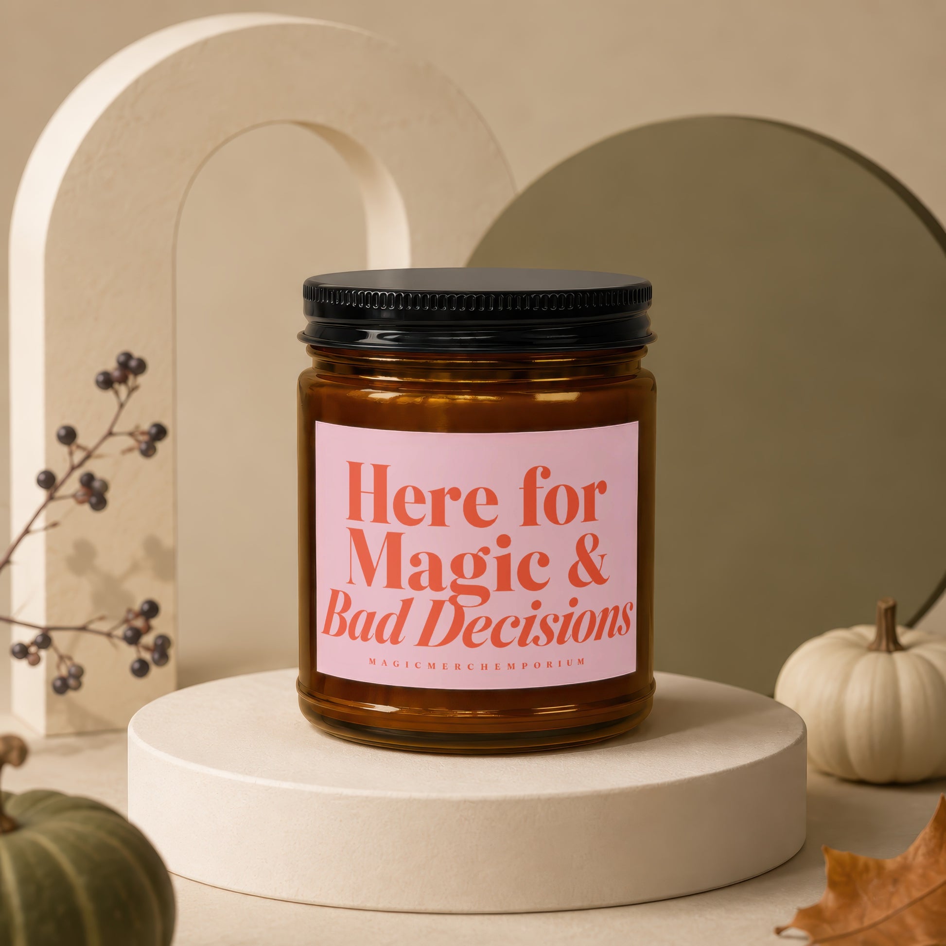 Amber jar candle with pink label reading "Here for Magic & Bad Decisions".