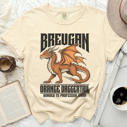 Cream t-shirt with an orange dragon graphic and text BREUGAN, ORANGE DAGGERTAIL, BONDED TO PROFESSOR CARR.