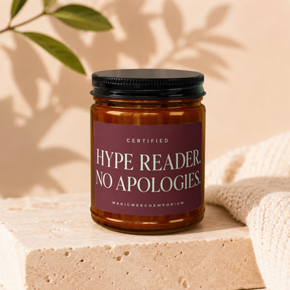 Amber jar candle with a maroon label reading "CERTIFIED HYPE READER NO APOLOGIES".