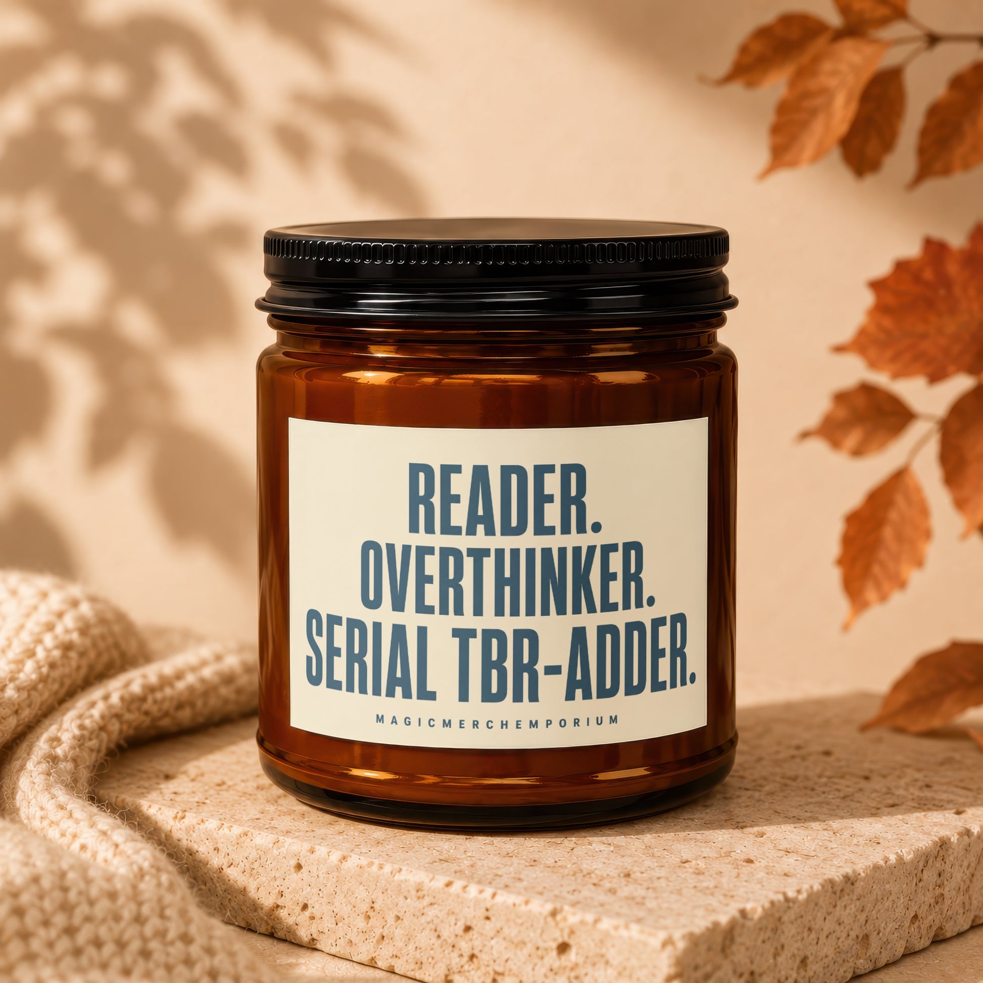 Amber jar candle with "READER. OVERTHINKER. SERIAL TBR-ADDER." text.