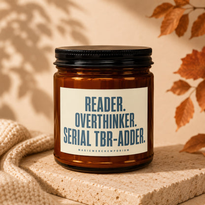 Amber jar candle with "READER. OVERTHINKER. SERIAL TBR-ADDER." text.