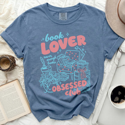 Blue t-shirt with "book LOVER never enough books OBSESSED CLUB" graphic.