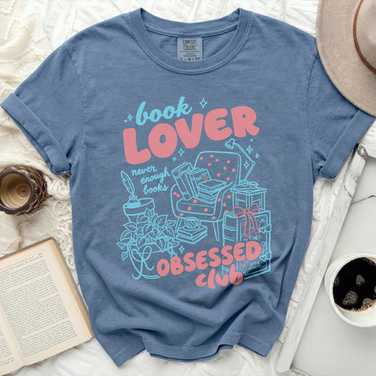 Blue t-shirt with "book LOVER never enough books OBSESSED CLUB" graphic.