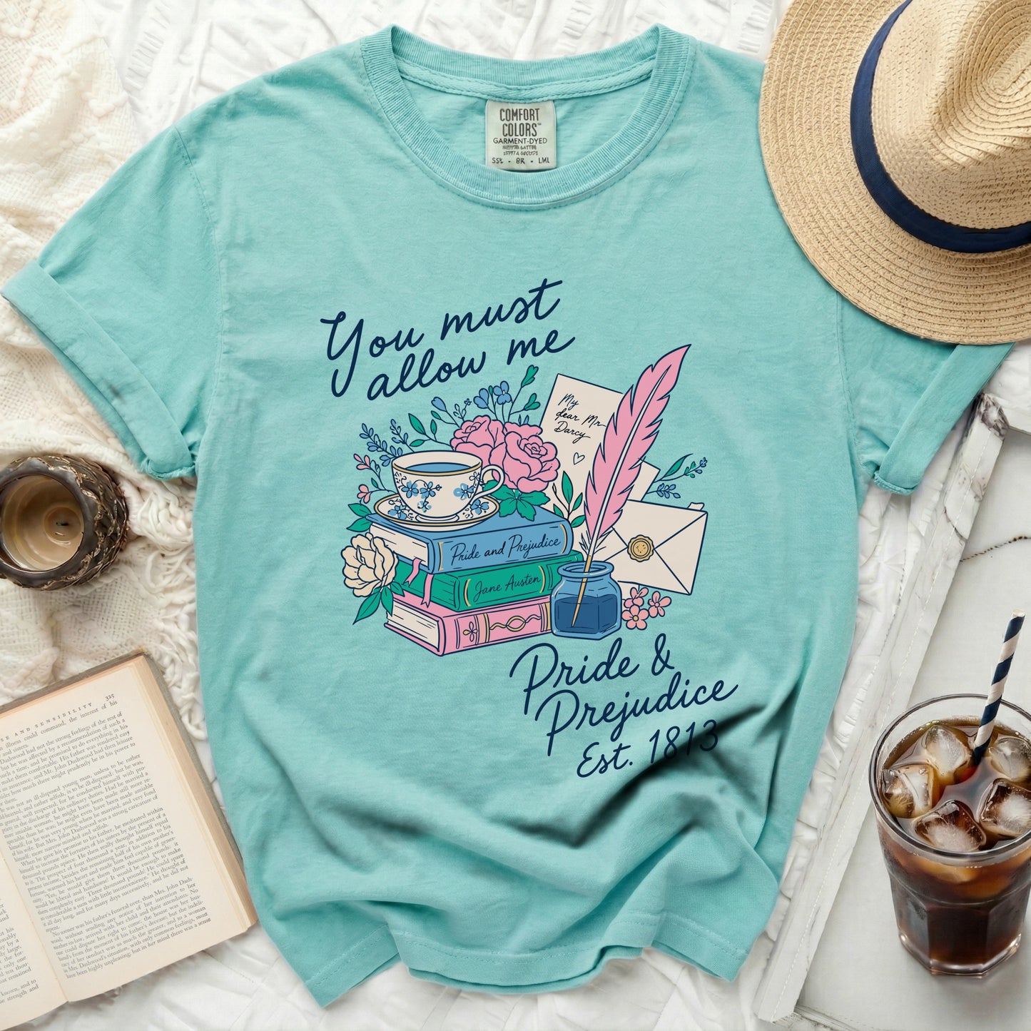 Teal t-shirt with "Pride & Prejudice" literary design featuring books, teacup, and quill.