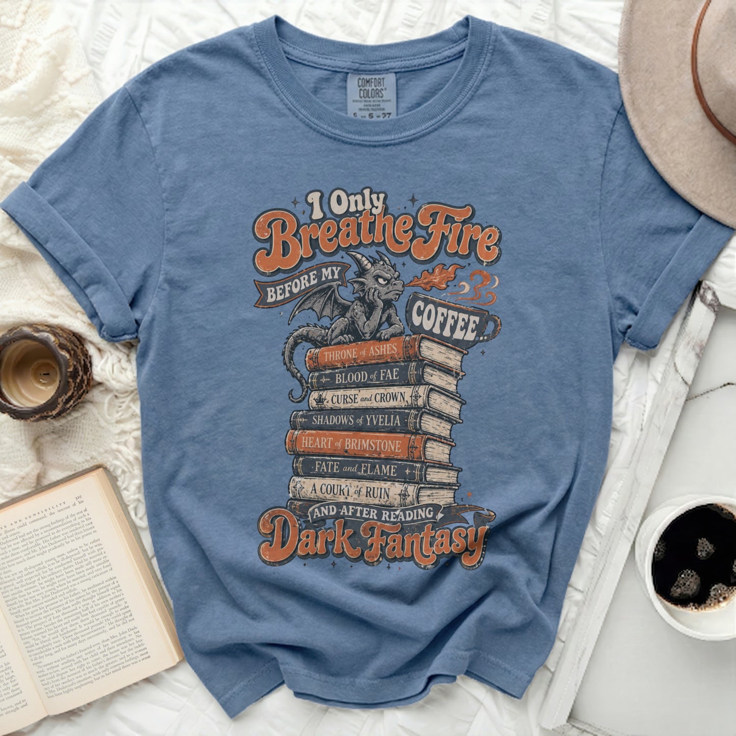 Blue t-shirt with "I Only Breathe Fire Before My Coffee and After Reading Dark Fantasy" text.