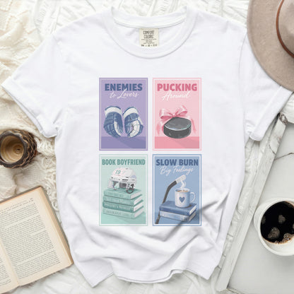 Four square graphic designs on a white t-shirt: hockey, puck, book, and coffee.