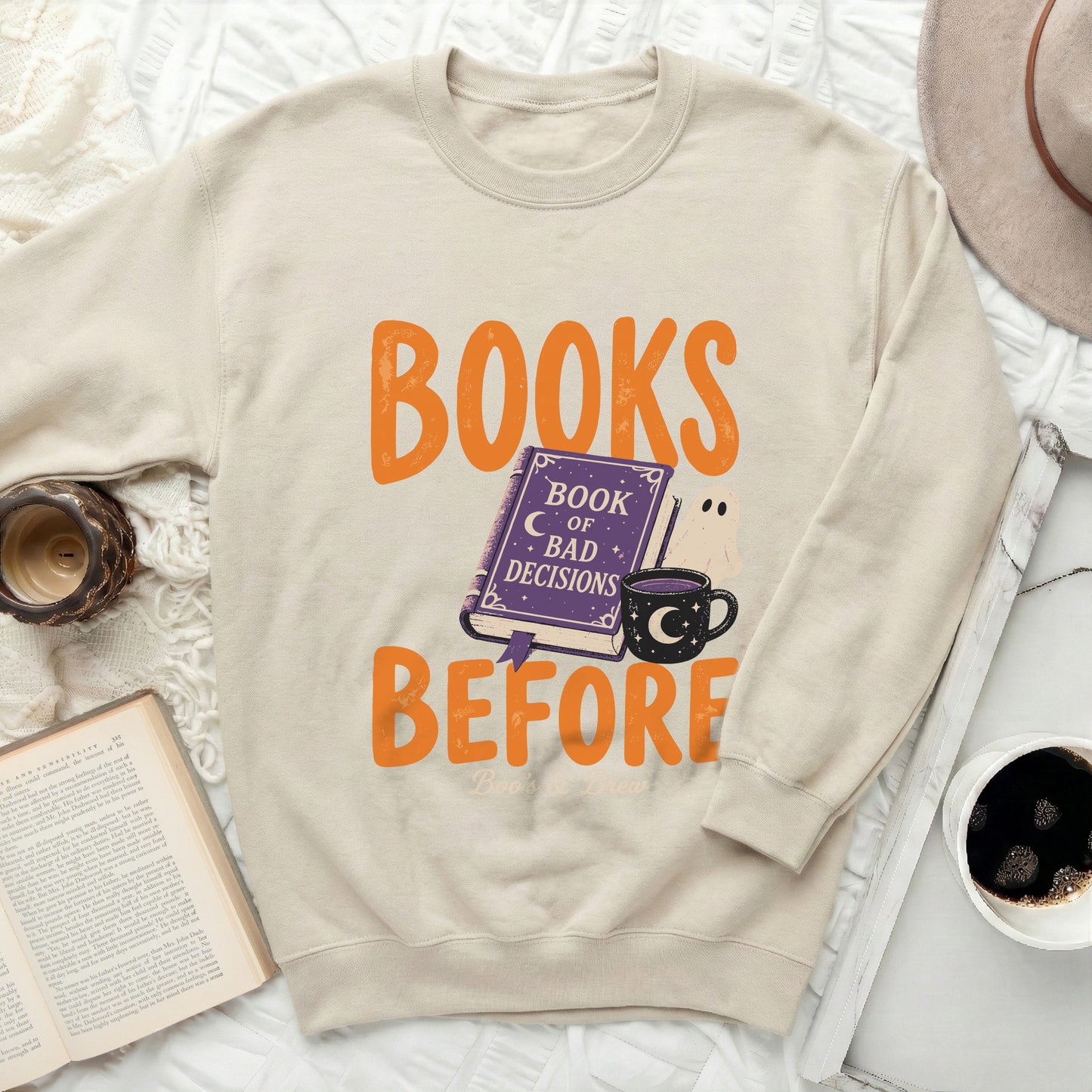 Cream sweatshirt with "BOOKS BEFORE BAD DECISIONS" text and Halloween graphics.