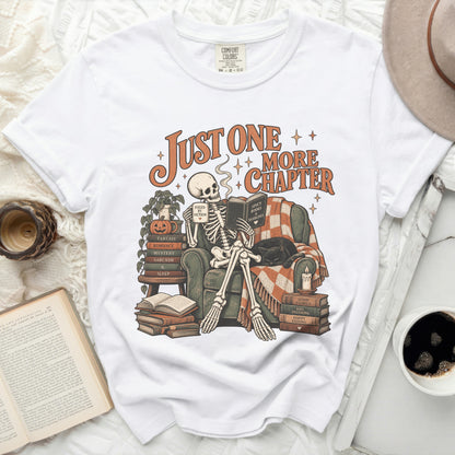 Skeleton reading with text "Just One More Chapter" and books.