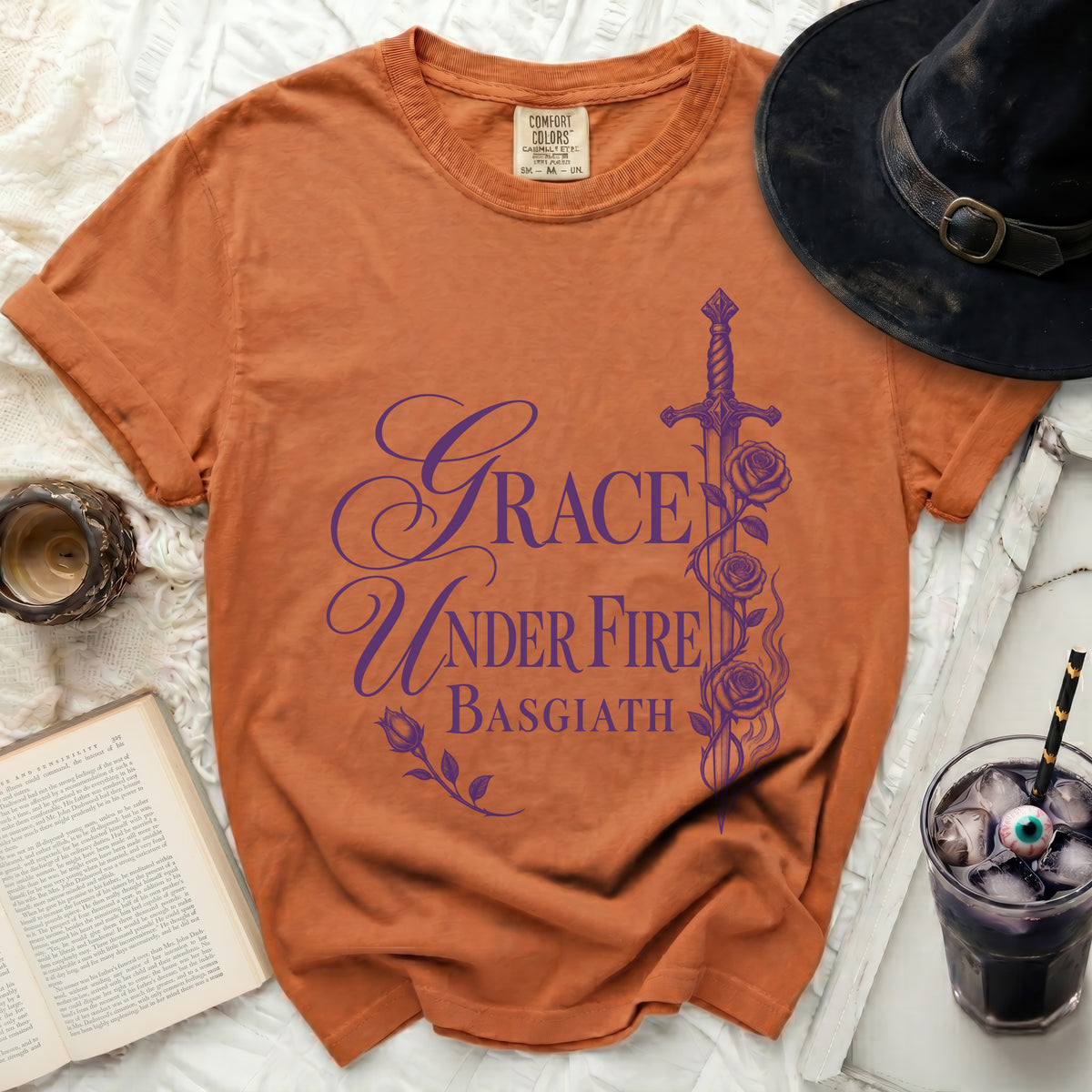 Orange t-shirt with purple "Grace Under Fire Basgiath" text and sword graphic.