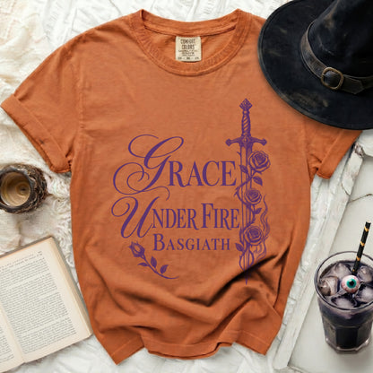 Orange t-shirt with purple "Grace Under Fire Basgiath" text and sword graphic.