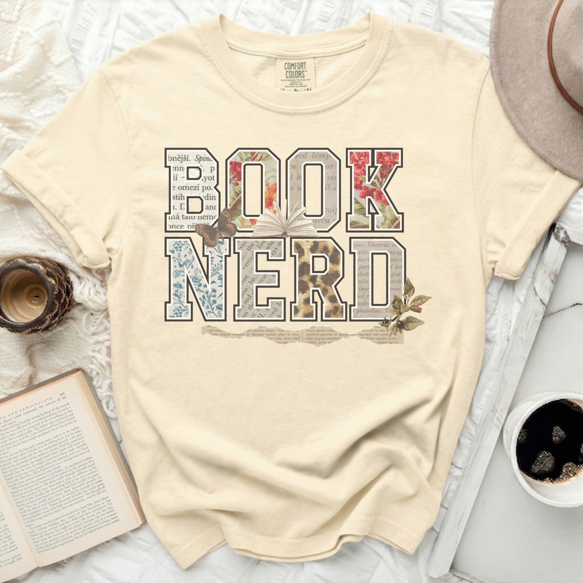 Comfort Colors t-shirt with "BOOK NERD" in floral, leopard, and newspaper print.