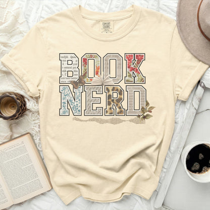 Comfort Colors t-shirt with "BOOK NERD" in floral, leopard, and newspaper print.