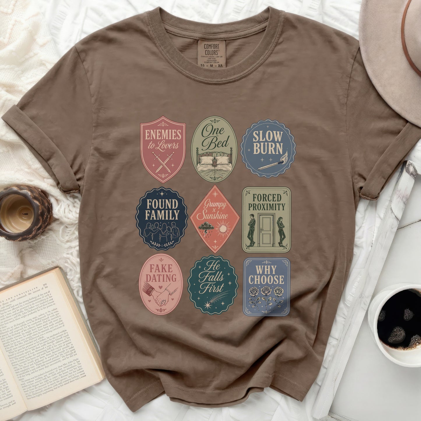 Brown t-shirt with nine literary romance tropes badges.